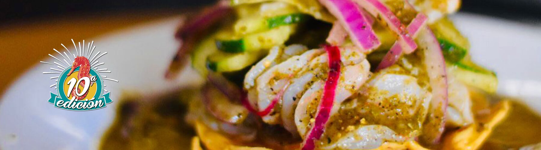 Close-up of a shrimp ceviche tostada with cucumber and red onion