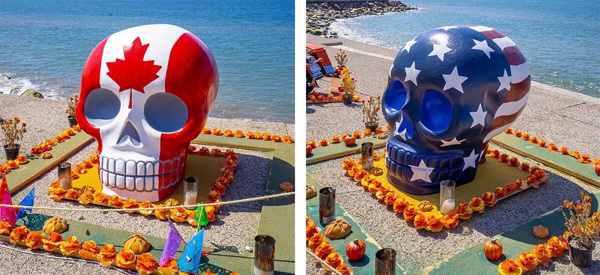 Large colorful skull sculptures of the Canadian and American flags on the Puerto Vallarta boardwalk.