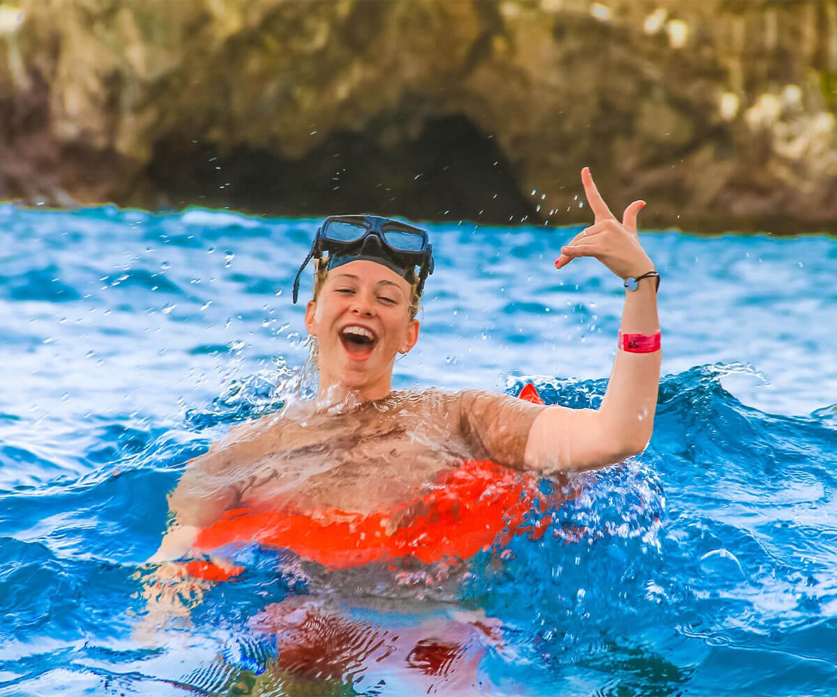 Smiling boy snorkeling in the crystal-clear waters of Puerto Vallarta.