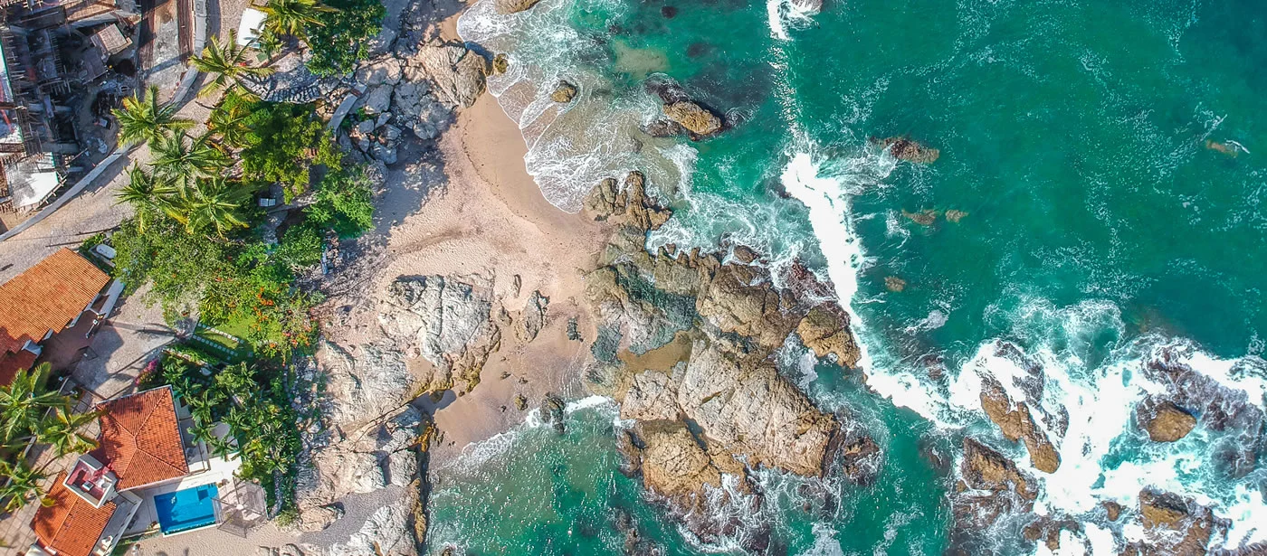 Aerial view of rocky beach, turquoise water, Puerto Vallarta.